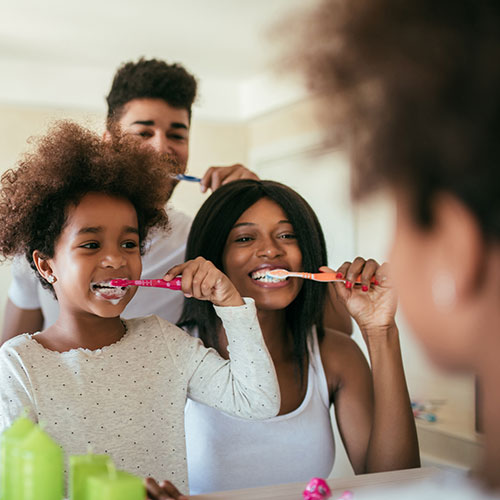 family brushing teeth