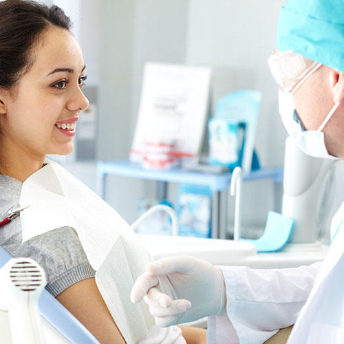 woman smiling at dentist teeth cleaning