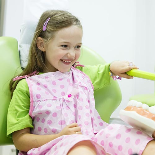 woman smiling at dentist teeth cleaning