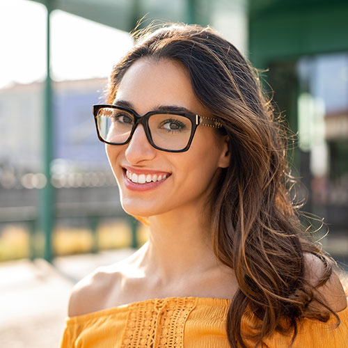 young woman big smile glasses 